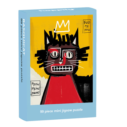 Puzzle box with a cat illustration in the style of Jean-Michel Basquiat Nia Gould. Box is on a white background.