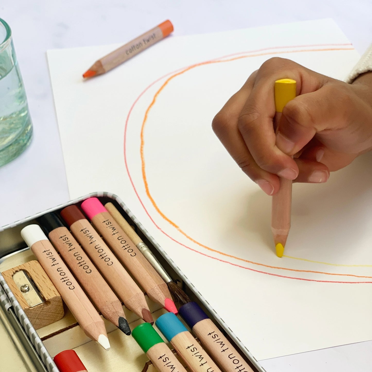 Coloring with colored pencils on a white sheet of paper