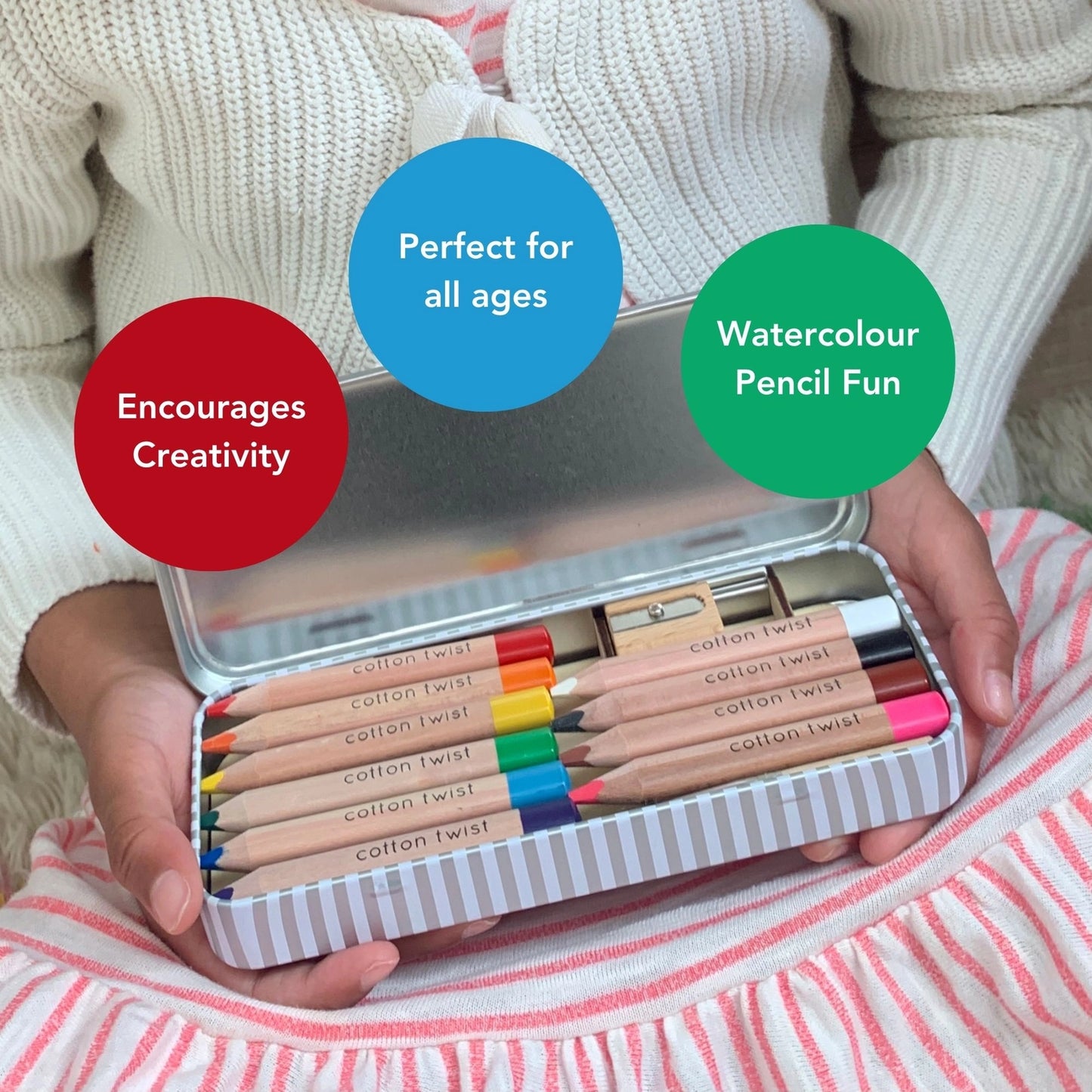 Child holding a set of watercolor pencils in a tin with text highlighting features.