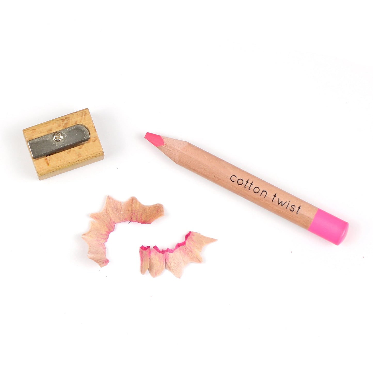 Pink pencil labeled 'cotton twist' with a wooden sharpener on a white background