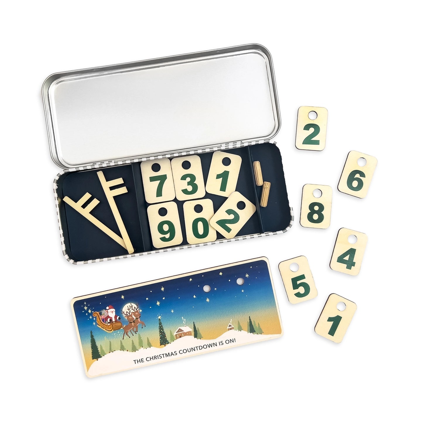 Christmas countdown calendar with numbered cards and a tin container on a white background