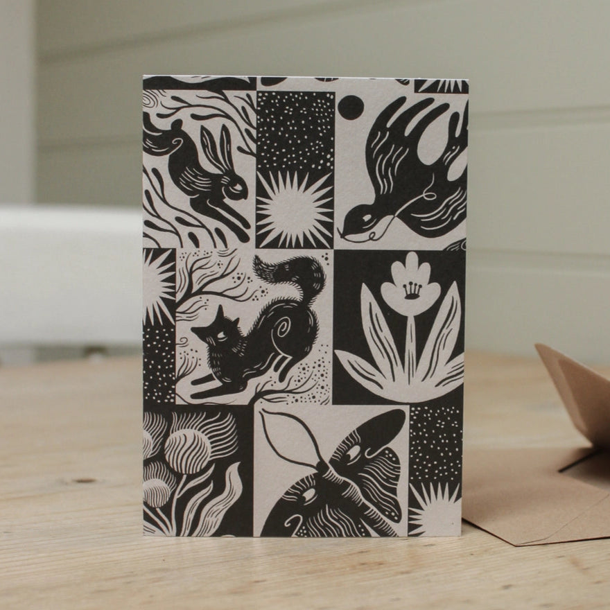 Countryside themed black and white card, featuring anilmals and flora.