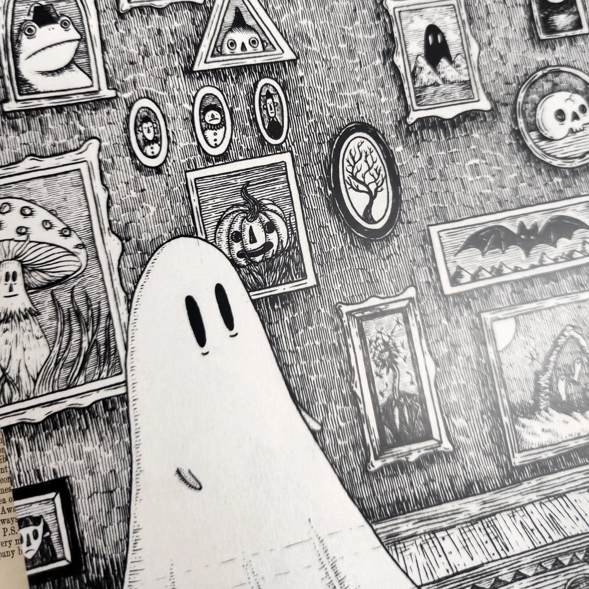Closeup of an artprint featuring illustrated gohost in a room filled with spooky framed images.