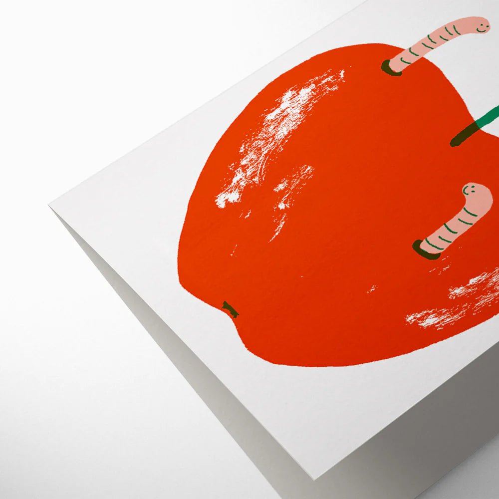 Red apple with worms on a white background