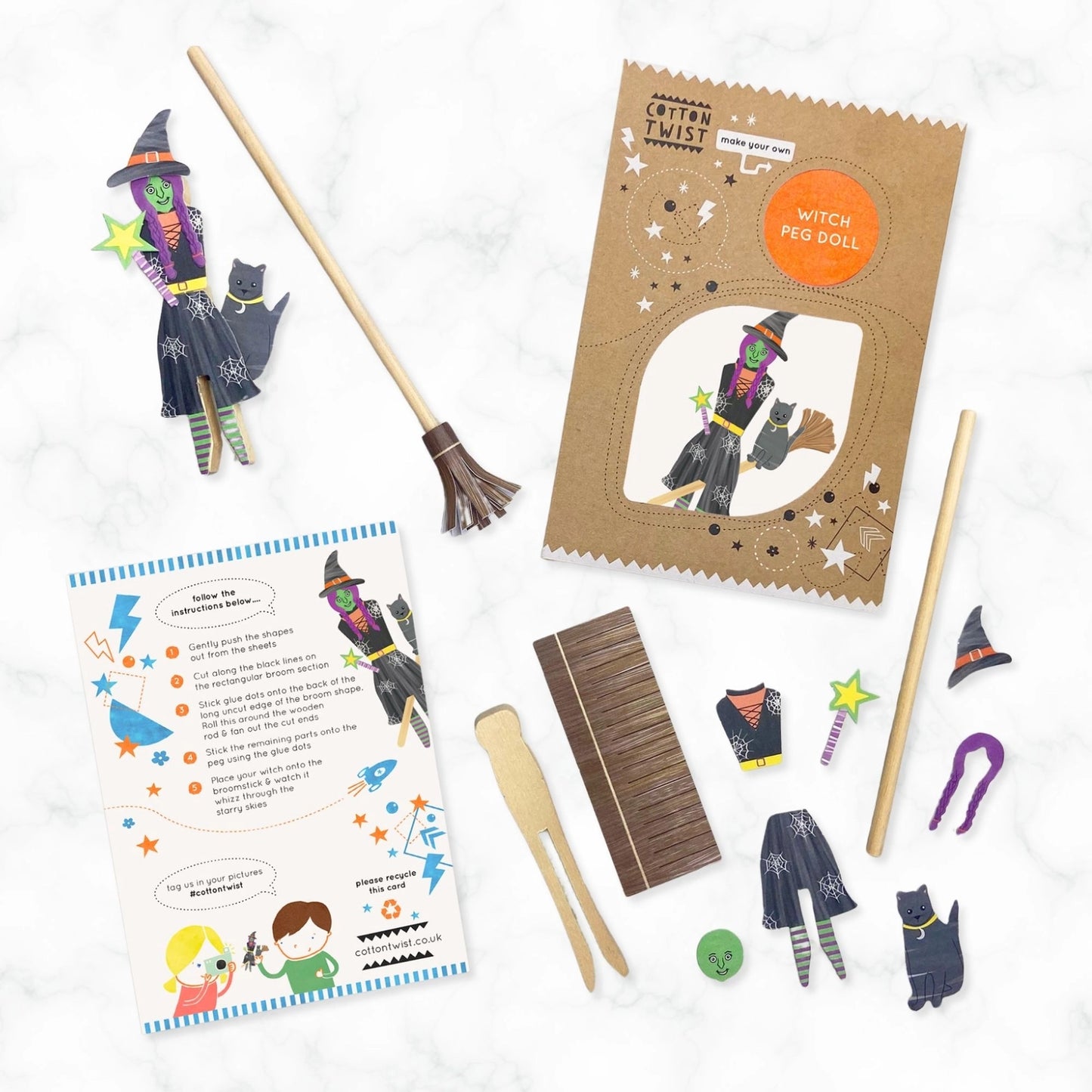 Witch-themed craft kit with broom, packaging, and instructions on a white background