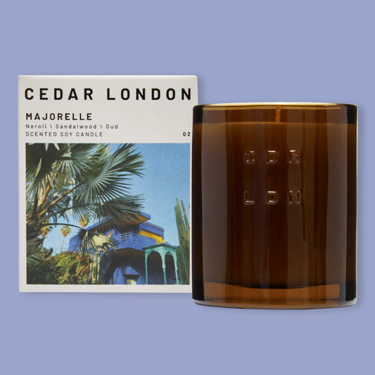 Cedar London Majorelle candle and packaging on a blue background