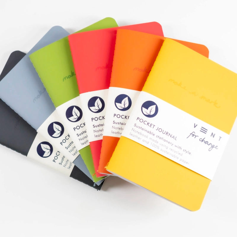 Set of colorful pocket journals with visible brand labels on a white background