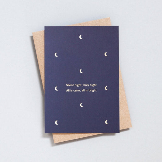 Navy blue Christmas card with small foil blocked moon motifs in brass, with the words 'Silent night, holy night, All is calm, all is bright'. With brown kraft envelope.