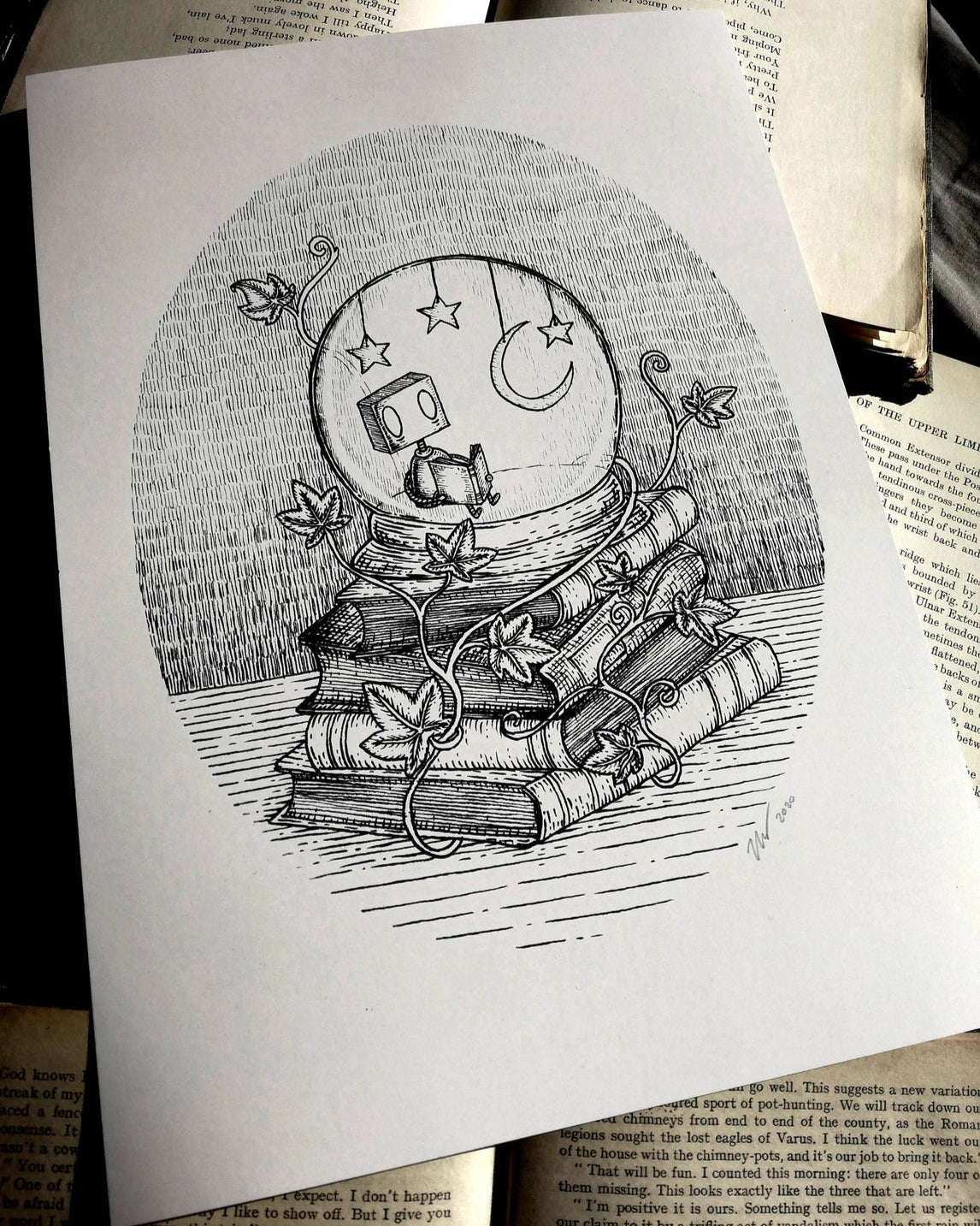 A white print with a black and white illustration of a little robot reading inside a starlit snowglobe on a stack of books.