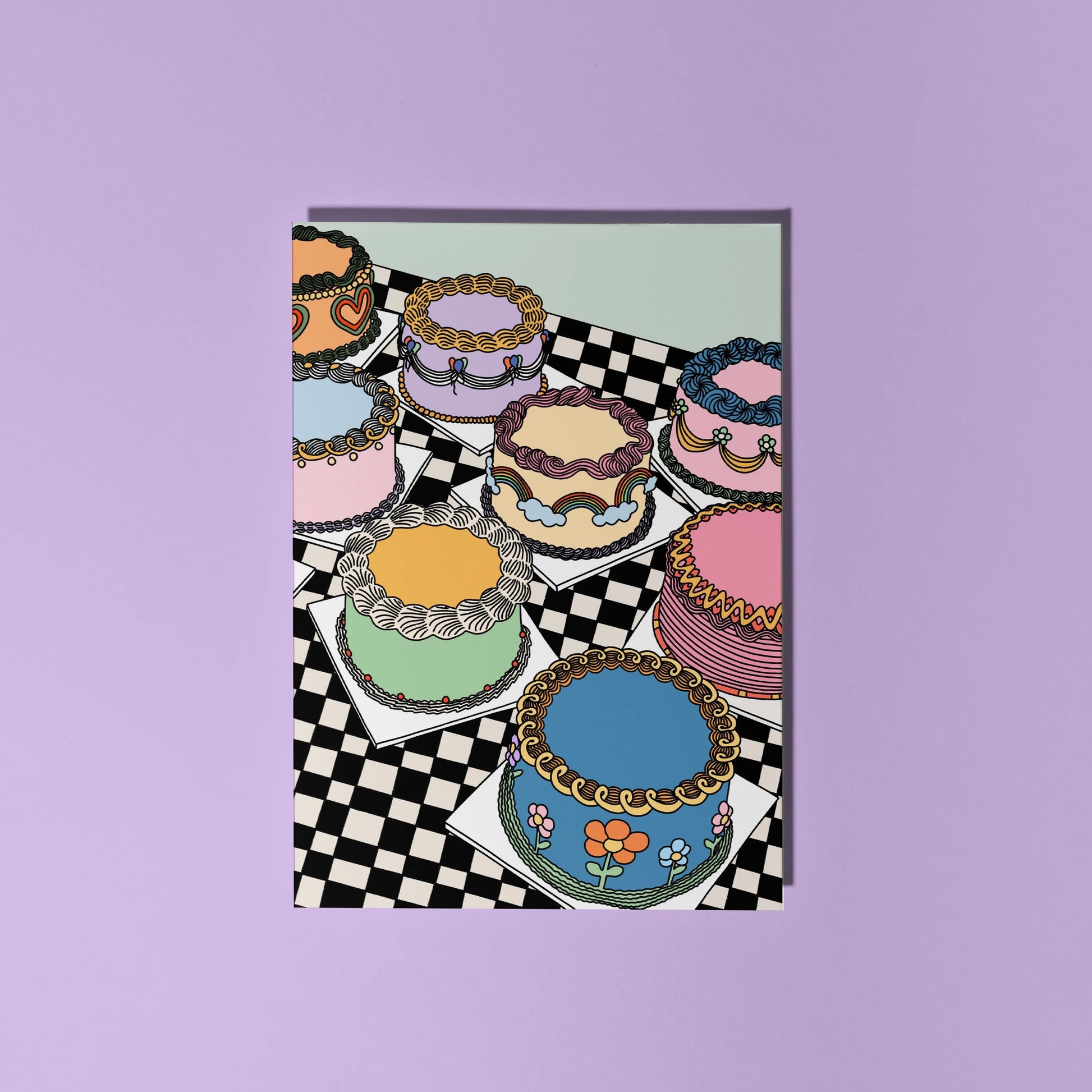 Colourful card featuring a checkerbaod table with an array of piped pretty cakes.