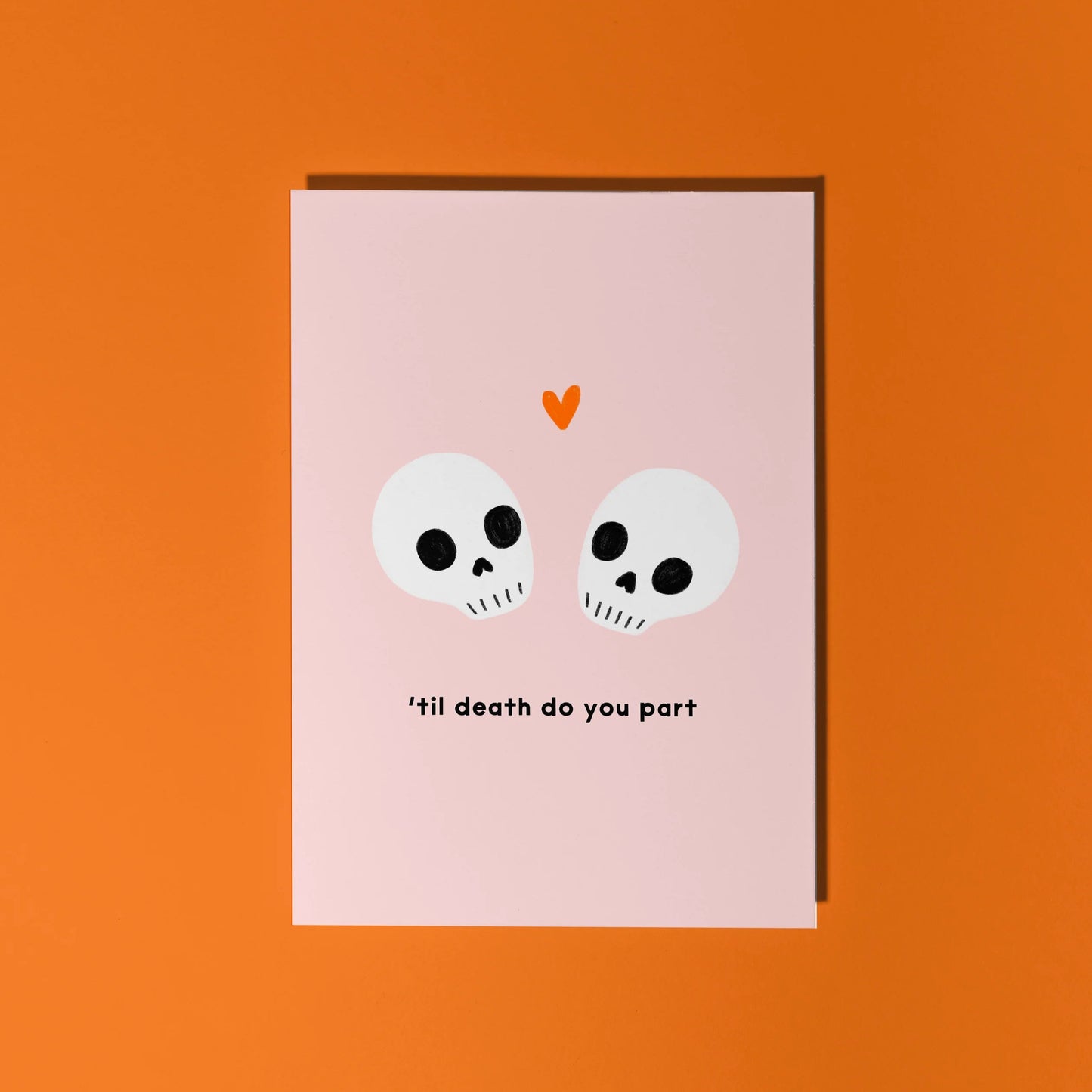 Humourous wedding day card with skuls and the phrase 'til death do you part' on a pink background.