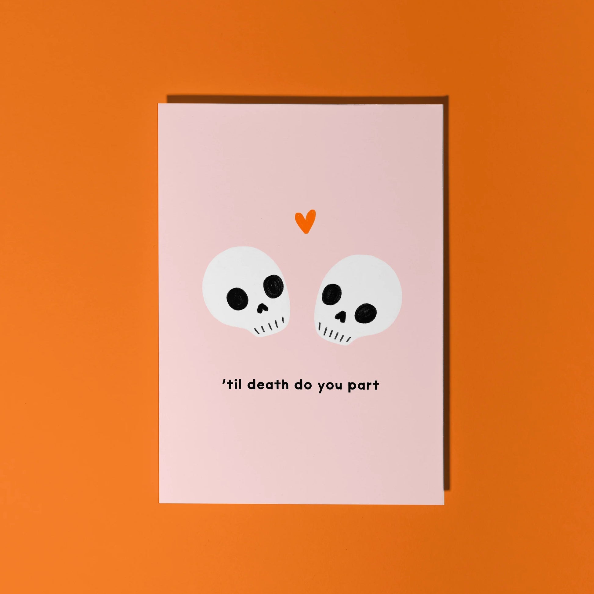 Humourous wedding day card with skuls and the phrase 'til death do you part' on a pink background.