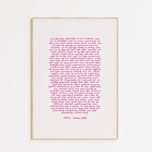 The words of Gloria's monologue in Barbie the film. Pink text against a white background in a thin wooden frame.
