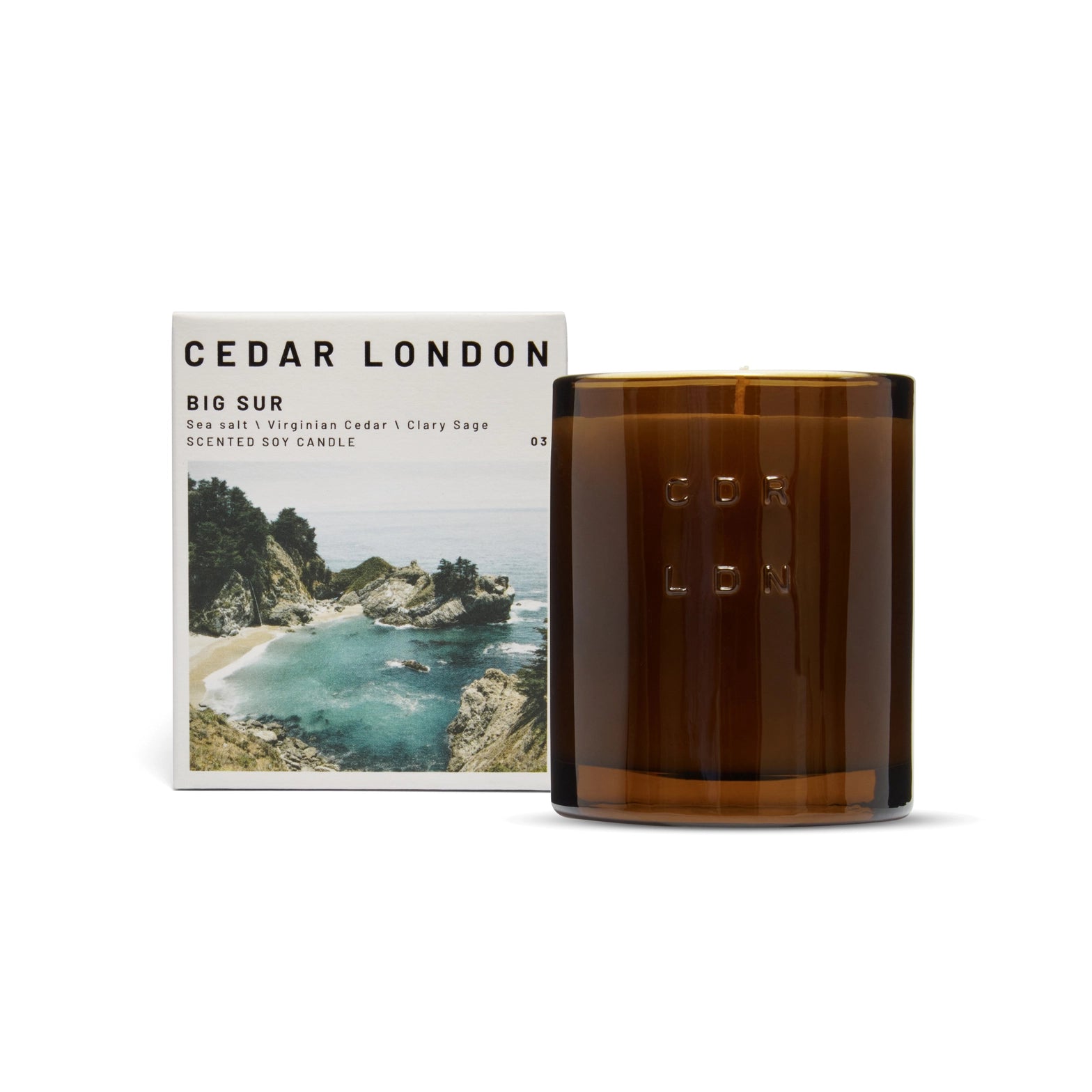Brown glass Big Sur candle with Cedar London packaging featuring a scenic image on a white background
