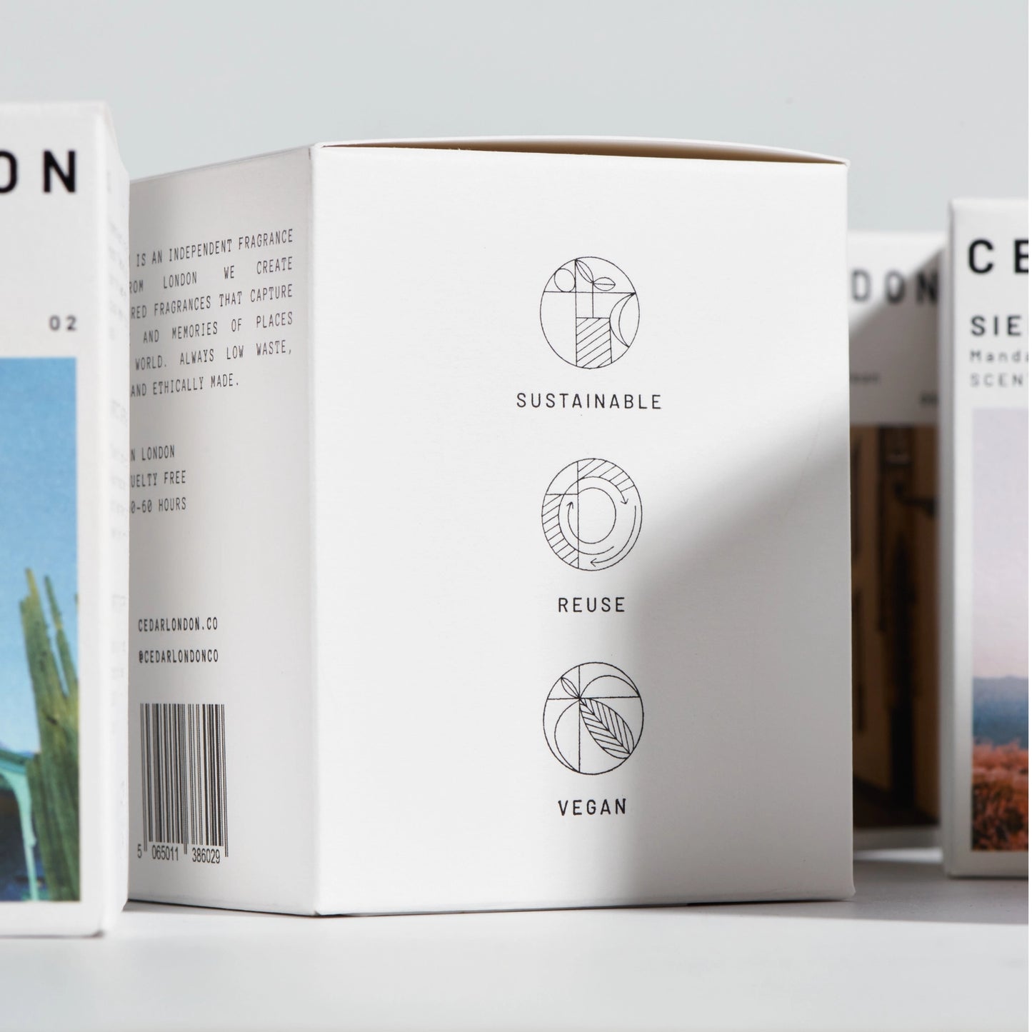 White product packaging with sustainability icons and text on a light gray background