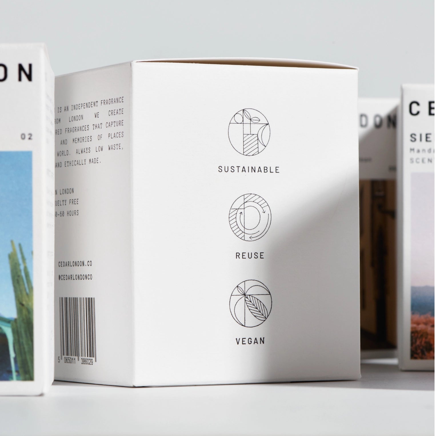 White product packaging with sustainability icons and text on a light gray background