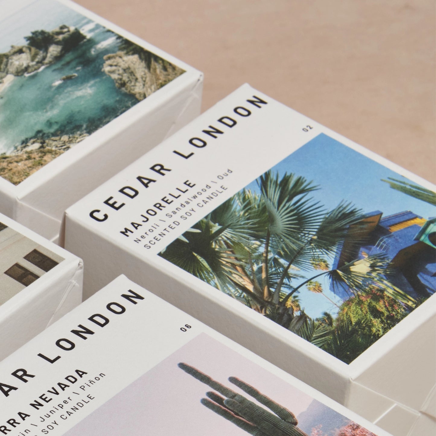 Cedar London candle boxes with scenic images on a beige surface