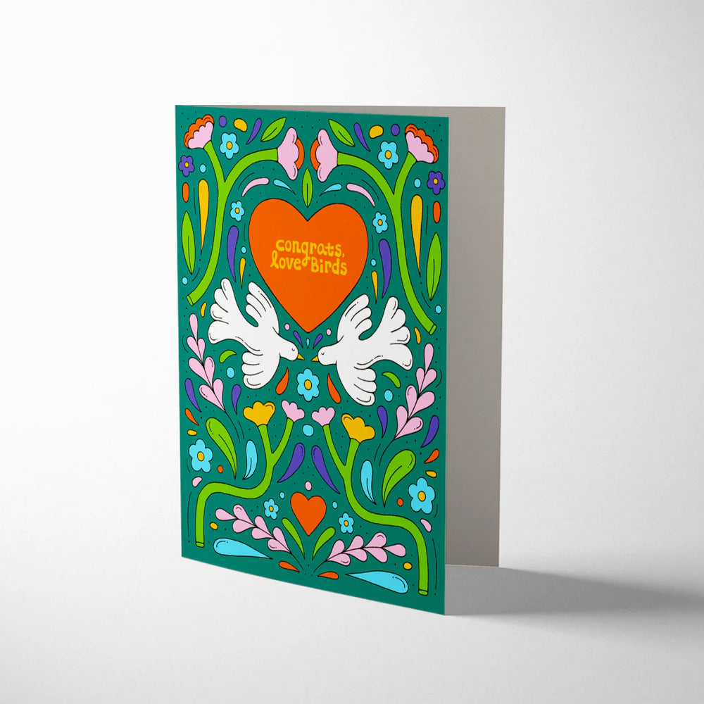 Greeting card with heart, doves, and floral design on a white background