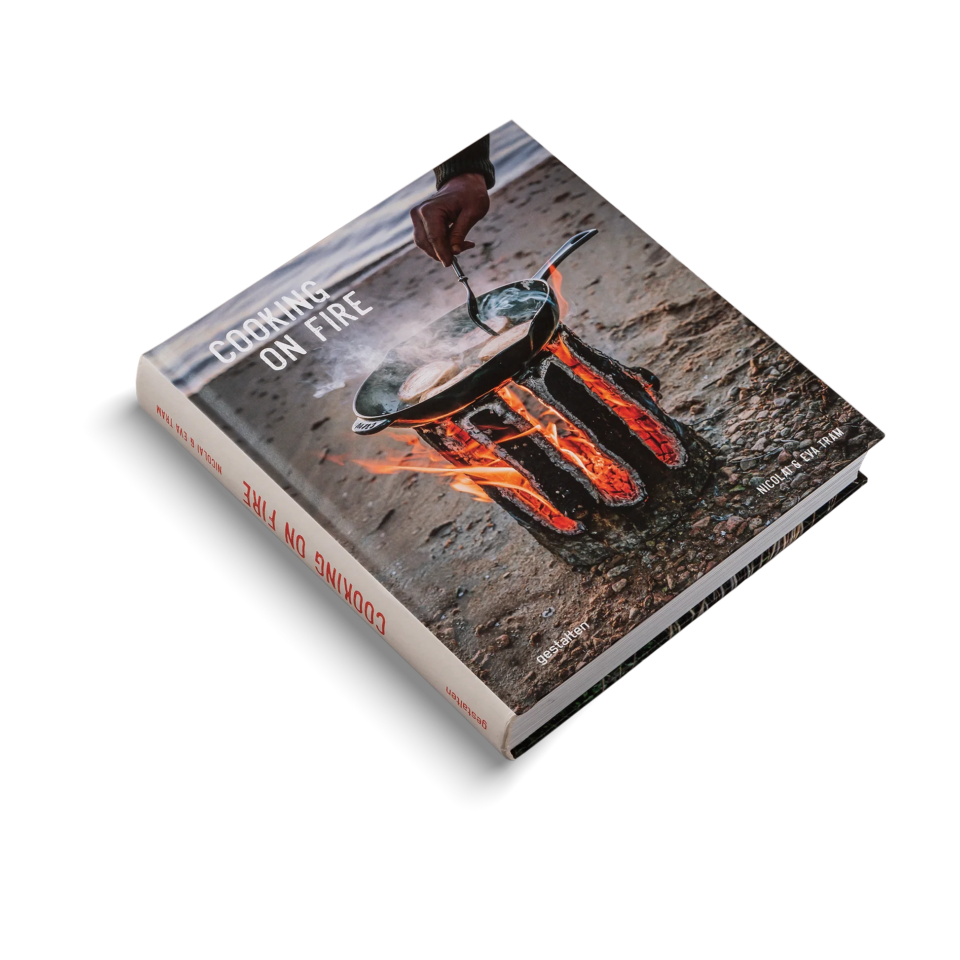 Book titled 'Cooking on Fire' with a photograph of a person cooking over an open flame on the cover.