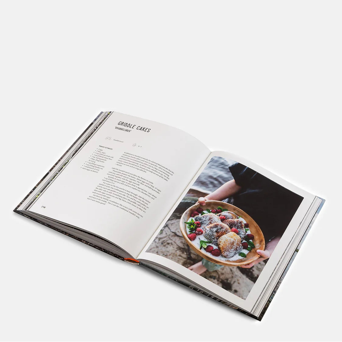 Open book showing a Griddle Cakes recipe with an image of a dish on a white background