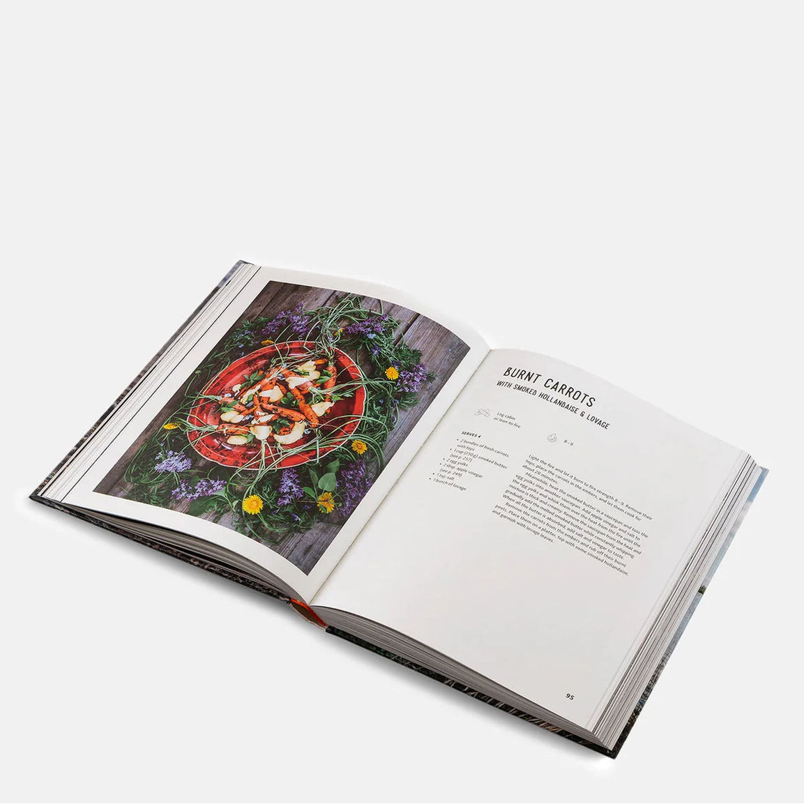 Open cookbook showing a Burnt Carrots recipe with an image of delicious food on a white background
