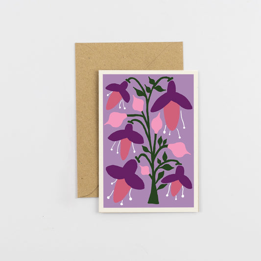 Greeting card with floral fuscia design on a purple background, featuring a brown envelope.