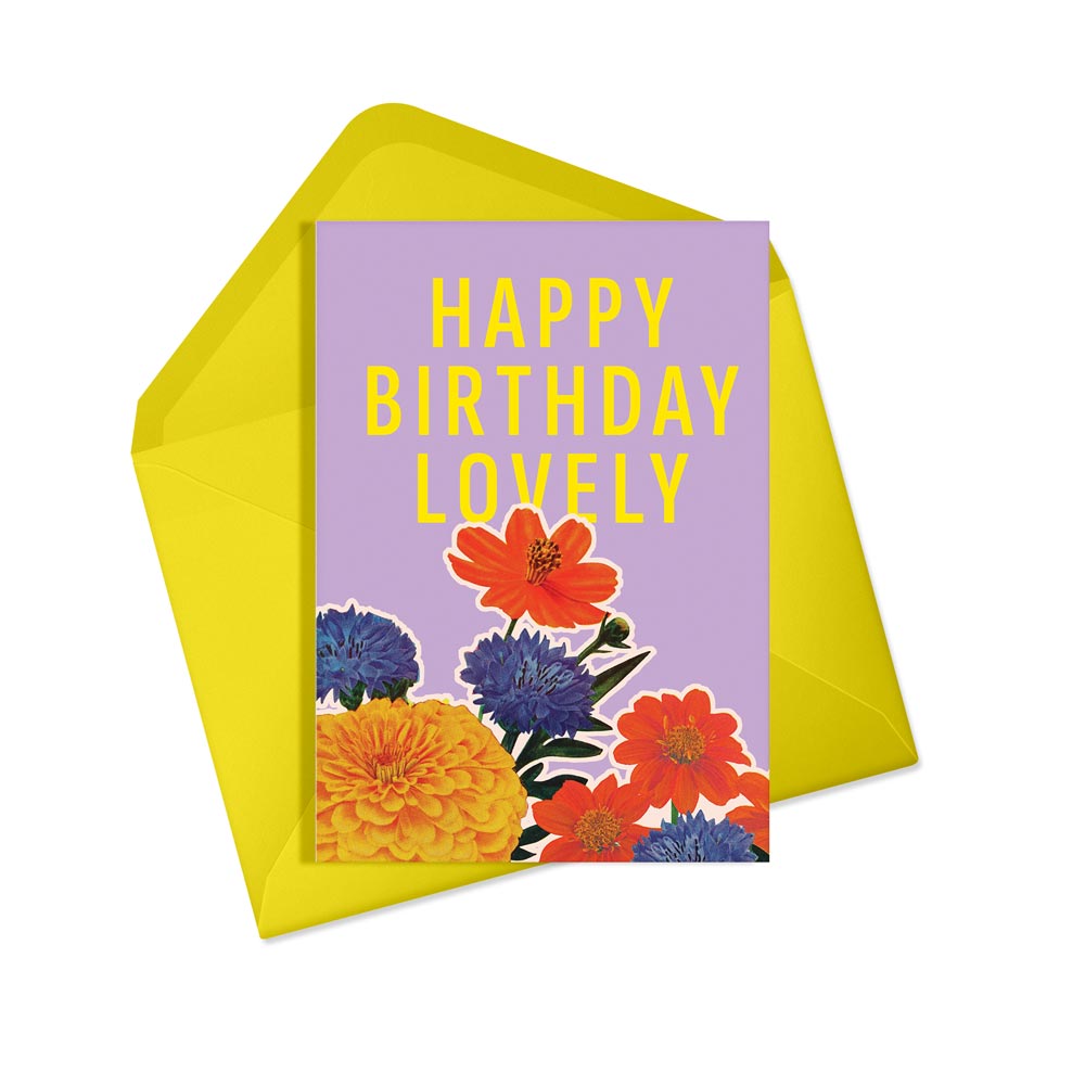 Purple card with colourful flowers and the text 'Happy Birthday Lovely' in yellow, with a yellow envelope, on a white background.