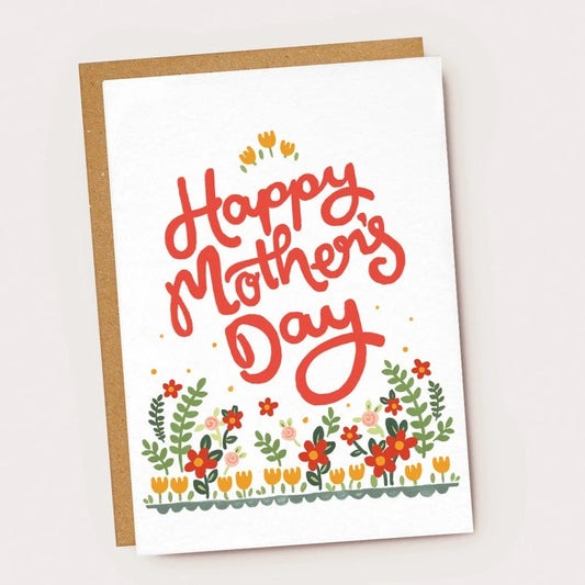 White card with colourful bed of flowers along the bottom and big red letters spelling 'Happy Mother's Day'