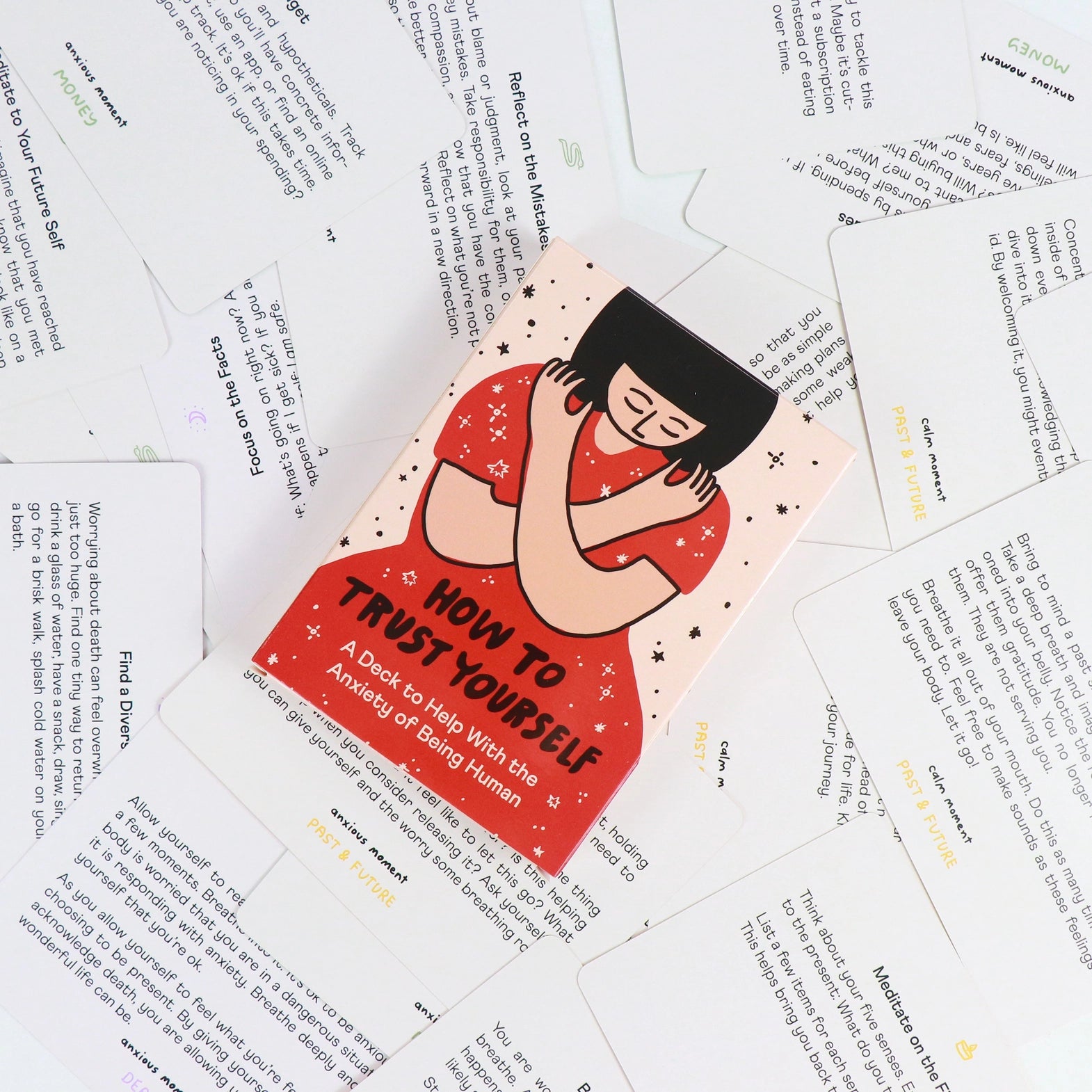Card with illustration of a person and text 'How to Trust Yourself' on a background of other cards.