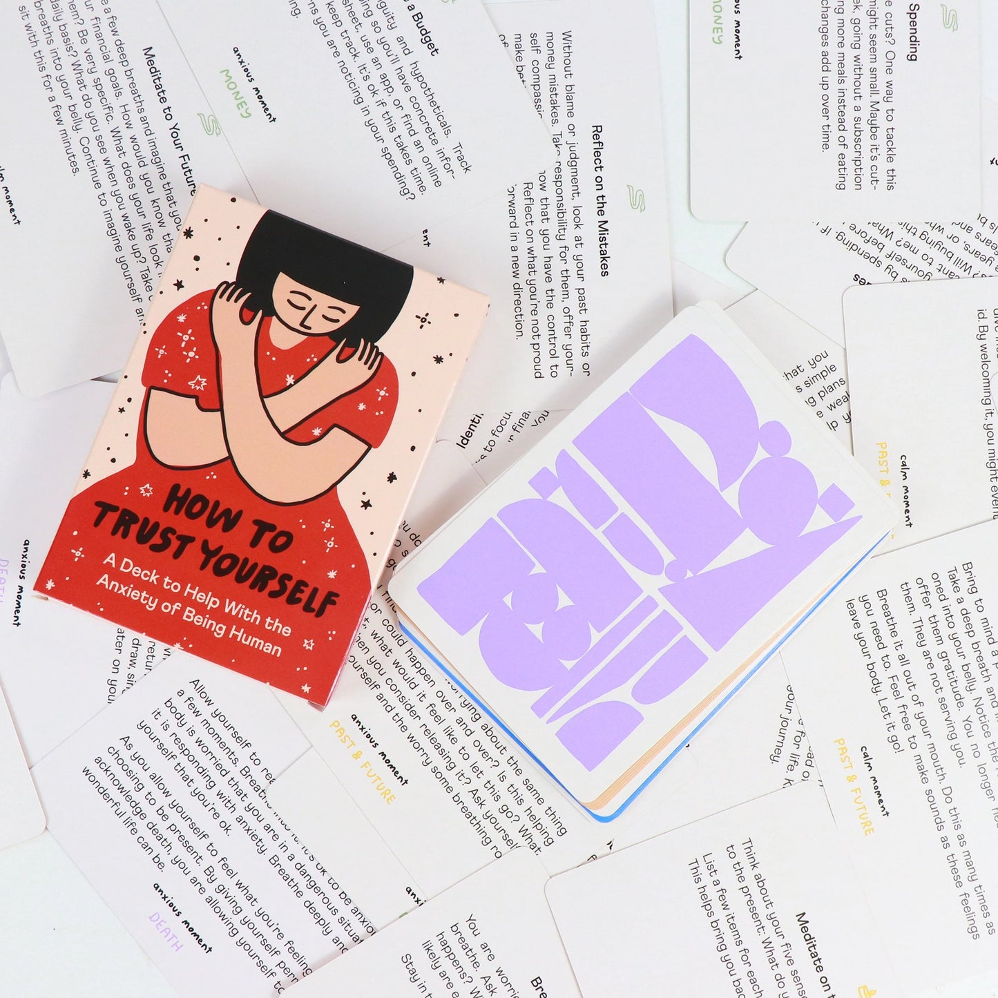 Card deck titled 'How to Trust Yourself' on top of printed cards with text.