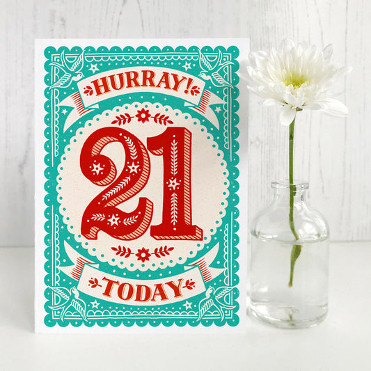 Handlettered, illustrated 21st birthday card with the text 'Hurray 21 Today'. text in red on aquamarine background.