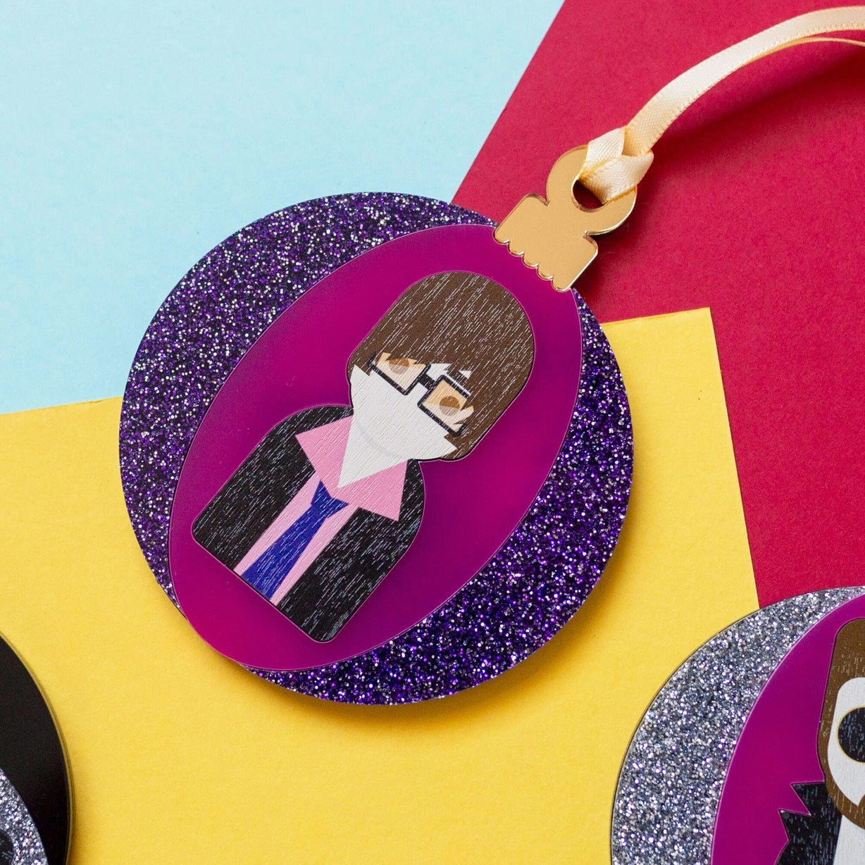 Glittery purple acrylic bauble featuring Jarvis Cocker.