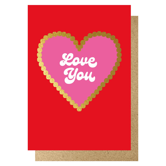 Red card featuring a scalloped gold hot foiled heart with a pink centre and the words 'Love You' in a white script.