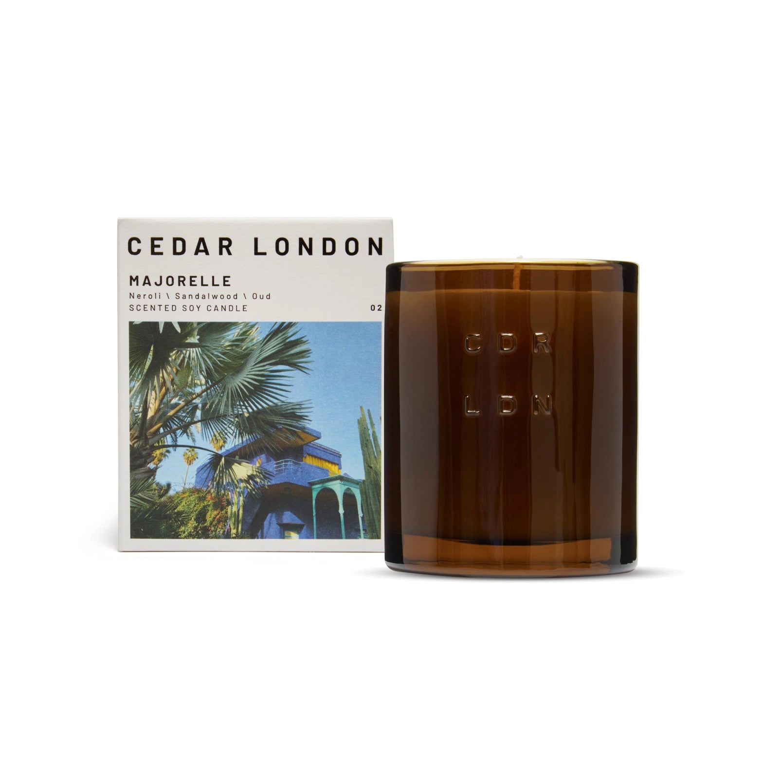 Brown glass Majorelle candle with Cedar London packaging featuring a palm tree design on a white background.