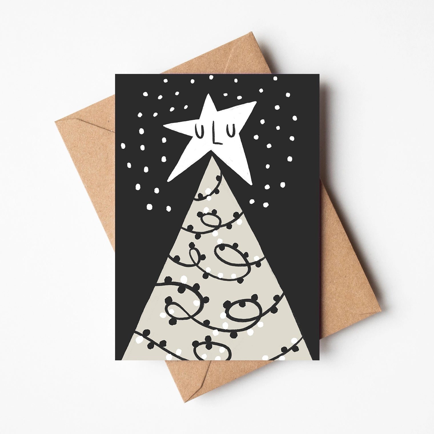 Sleeping star on top of a christmas tree in the nighttime. Handrawn illustrated, monochrome card with a brown envelope.