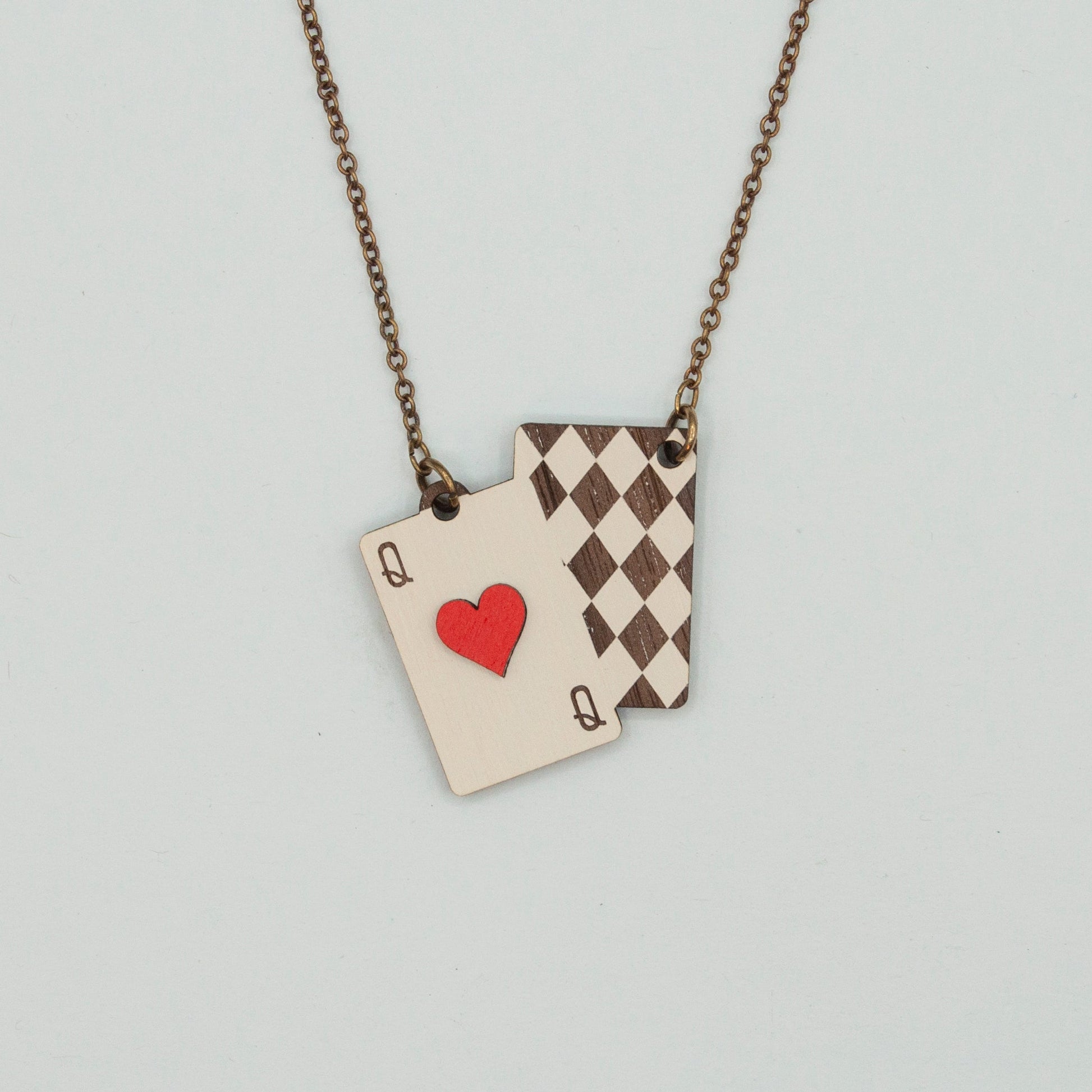 Necklace with playing card charms on a light gray background