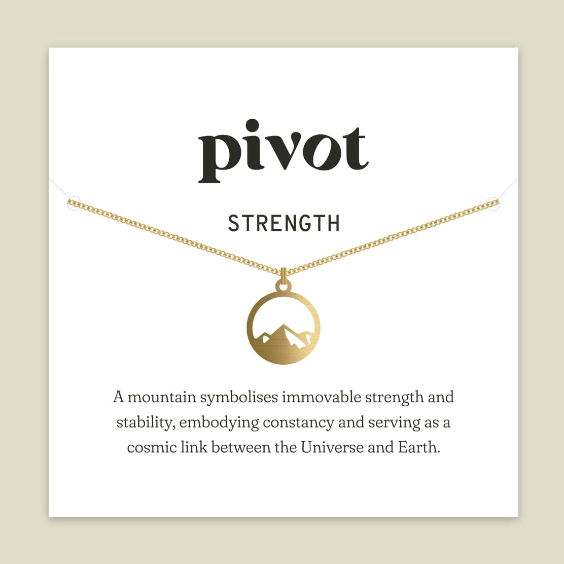 A brass necklace with a circular pendant featuring a mountain silhouette, displayed on a white card labeled 'pivot STRENGTH' against a beige background.