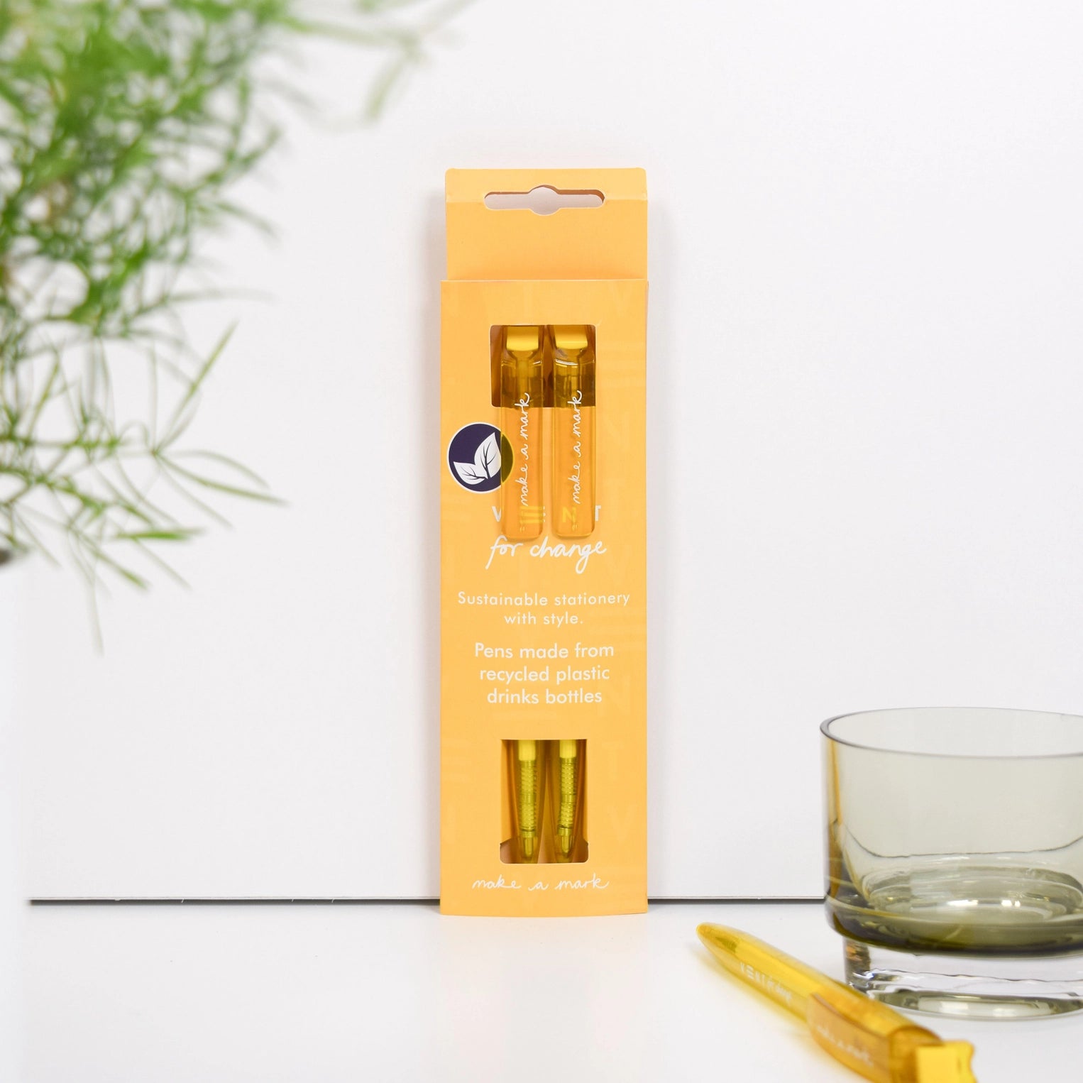 Pack of two yellow ballpoint pens made from recycled plastic, against a grey background.